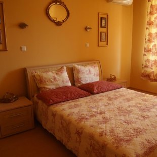 The specious bedroom is decorated in a chinoiserie style.