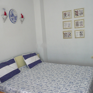 The queen bed in one of the bedrooms.