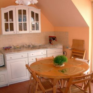 The fully equipped eat-in kitchen opens to the enormous terrace to the north.