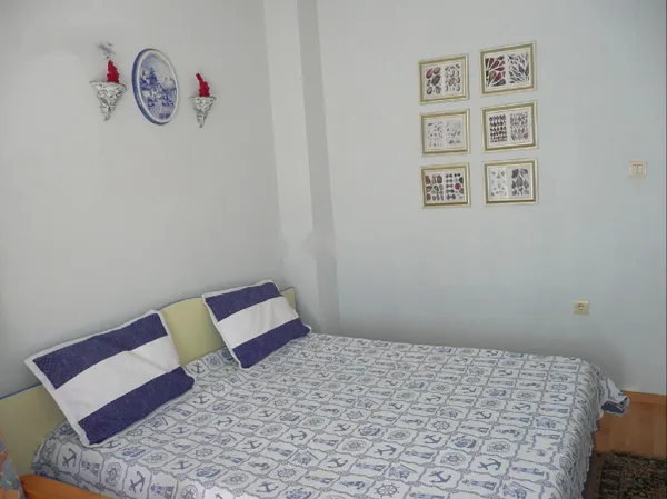 The queen bed in one of the bedrooms.
