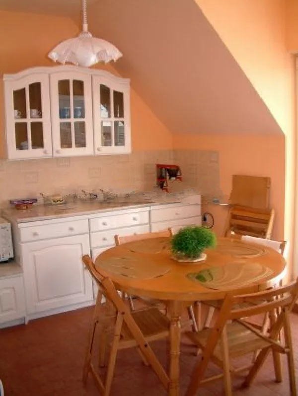 The fully equipped eat-in kitchen opens to the enormous terrace to the north.