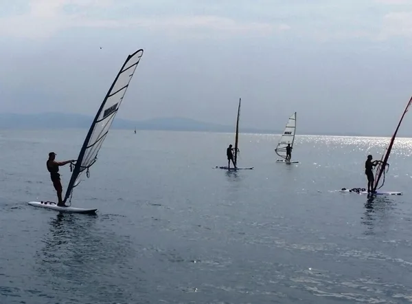 Windsurfing lesson for different levels of mastery are offered at a couple of locations.
